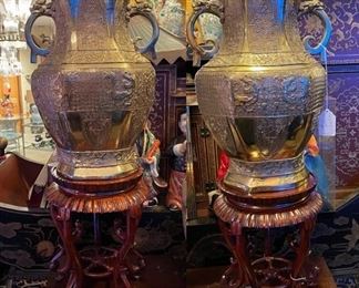 Magnificent large pair of Chinese brass vases on mahogany stands