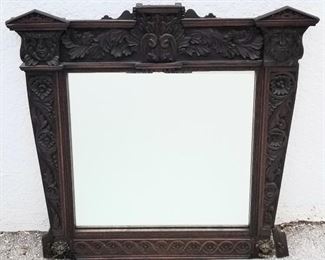 Beaux Arts mirror with faces and lion rings.
