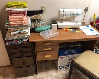 Brother sewing machine.  Sewing desk.  Storage bench.  Fabric.
Storage Bench: 18”tall • 15” square 