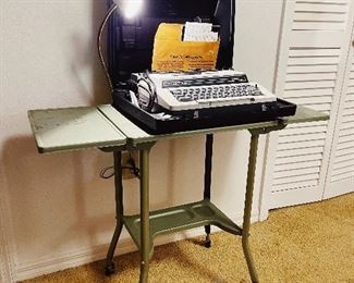 Smith Corona electric typewriter with carry case. 
Green metal rolling typewriter table with attached desk lamp. AWESOME!!! 