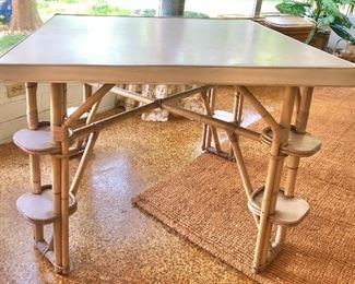 Vintage Rattan Game table, padded white vinyl top with side shelves. 