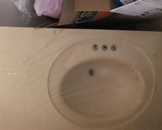 One piece countertop and bathroom cultured stone sink.