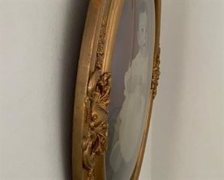 Antique wall frame with curved glass.