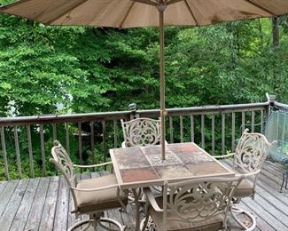 This is a patio set of furniture with a table that has ceramic tiles on top and comes with an umbrella and 4 cushion chairs that rock. Umbrella does have some holes in it but opens and closes fine 39x39x29 Chairs: 24x24x38” https://ctbids.com/#!/description/share/974629