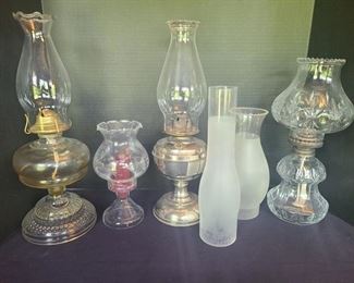 Three oil lamps largest one measures 6" x 17". Two extra hurricane glasses and a beautiful candle holder with the same look. https://ctbids.com/#!/description/share/974526