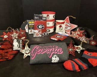 Georgia Bulldog Collection: Two sparkly koozies, temporary tattoos, a scarf, slipper socks, two keychains, porcelain container, three plastic storage containers with lids, handcrafted ornaments, and a t-shirt (ladies size XXL). All new or in good used condition. The handcrafted ornaments are in handmade and stored condition. Some rhinestones are displaced but are usually found stuck to another piece. They are easily put back in place. https://ctbids.com/#!/description/share/974315
