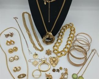 This is a fantastic set of gold tone costume jewelry. It includes pieces by Napier. First necklace on stand measures 30" with and extender for 2" more. The longest double chained necklace measures 42". https://ctbids.com/#!/description/share/974324
