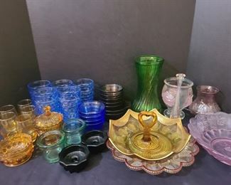 Pinks, yellows, blue, green and black colored dishes. Cups, candle holders, small custard dishes, egg tray and some more. https://ctbids.com/#!/description/share/974559