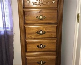 Oak lingerie chest with drawers has brass pulls and white knobs. Dresser has a beautiful carved floral pattern on the top drawer. It measures 24x18”x55”.  The drawers width measures 17” and the depth is 5”. https://ctbids.com/#!/description/share/974458