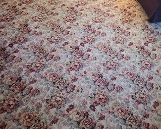 Large area rug is a tan color with the roses and leaves making up the extra colors. Measures 11ft (137") x 8ft (106"). https://ctbids.com/#!/description/share/974471