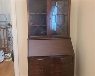 Beautiful secretary desk with glass door hutch. Desk has a key that locks the front cabinet and desk door. The desk has four drawers for storage as well as multiple slots to store letters and documents.  Measures 31" x 17" x 76". https://ctbids.com/#!/description/share/974587