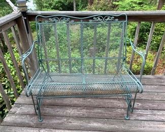 This is a wrought iron bench with a rocking or swinging mechanism built into it. It has a few spots that show some rust but it’s sturdy overall. 47x30x36 https://ctbids.com/#!/description/share/974625