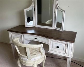 Gorgeous farmhouse vanity with drawers and a trifold mirror. The chair has a cane back, white seat cushion and swivels.  Vanity: 54 x 18 x 55" Chair: 17 x 31". https://ctbids.com/#!/description/share/981194