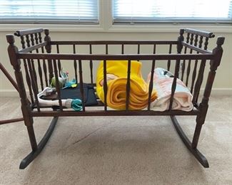 Antique cradle and some baby odds and ends. Cradle has been repaired over the years and measures 36 x 18 x 27".  https://ctbids.com/#!/description/share/981221
