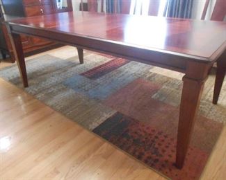 The dining room table with (1) leaf is gorgeous!  The rug is for sale as well.