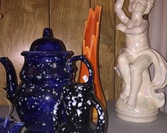 An orange swung vase with a host of lovely ceramics. 