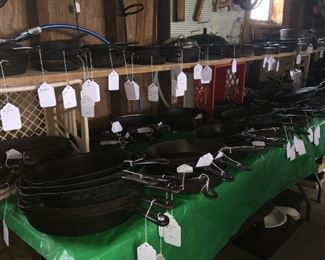 Nearly 150 pieces of cast iron, including skillets, Dutch ovens, miniature potbelly stove and cookstove, figures and trivets. 