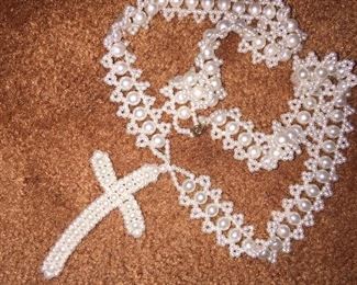 A beaded cross handcrafted from faux pearls. 