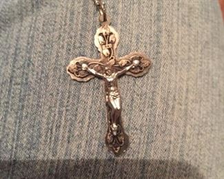 A crucifix pendant is among the many pieces of costume jewelry. 