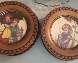 Classic Hummel characters encased in wood, about 6-inches in diameter. 