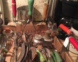 Vintage kitchen tools with red or green handles. 
