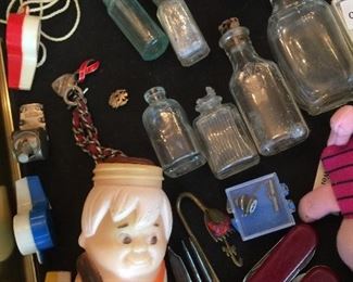 Miiniature glass bottles, Bam Bam Rubble bottle, small pocket knives and a plethora of small goods. 