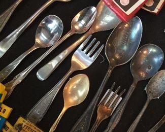 Commemorative and baby spoons along with vintage firecrackers. 