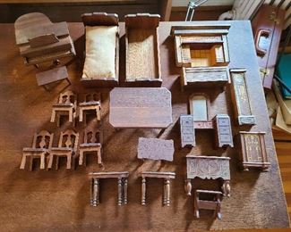 Marked Strombecker Playthings USA
1.Grand piano with matching bench printed ppr keys open top metal foot petals.
2.2 matching beds one with mattress 6" l
3.Dining table with 5 chairs 
4.Really nice faux brick tile fireplace  3.75"h.
5.Ladies art deco ladies vanity with mirror molded drawers 
6. Upright radio with painted front.\
7. Grandfather clock paper face gold painted
8.Buffet dining with molded front
9. End table / magazine holder
10. Deco hope chest with opening lid
11. 2 matching tables missing 2 legs on one table 
12. one unmarked walnut table needs glue