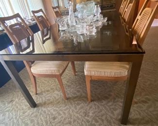Glass top dining table with 1970's era chairs