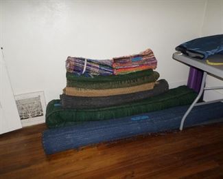 Woven rugs of various sizes.