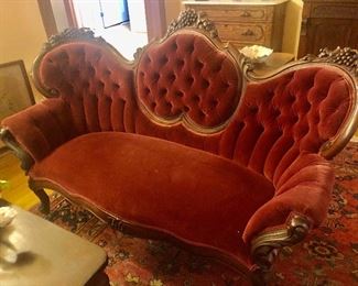 One of Two Rococo Revival Walnut Grape Carved Sofas. 