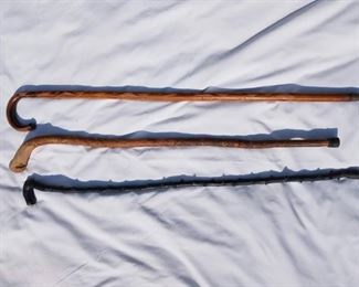 Lot Number:	173
Lead:	3 Vintage Wooden Canes
Description:	black cane- 36" curved handle- 36" carved cane w/ brass tip- 38"