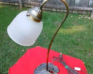 Lot Number:	179
Lead:	Brass Lily Pad Base Lamp
Description:	swirl design on posted glass shade base 6" diameter; 16" tall