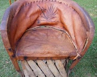 Lot Number:	181
Lead:	Hand-Made Native American Chair
Description:	unusual; rounded back frame made from wood limbs and hand tied has design etched into back; has design on animal hide
