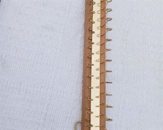 Lot Number:	233
Lead:	Tie & Belt Rack
Description:	wall mounted; 19" by 2" 36 brass hooks & 4 belt hooks
