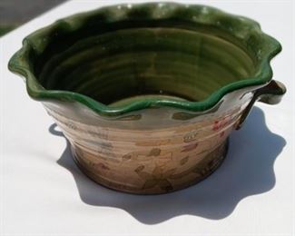 Lot Number:	287
Lead:	Pottery Planter/ Fruit Bowl
Description:	rippled edges; glazed; flower design on front 9" diameter by 4.5" tall