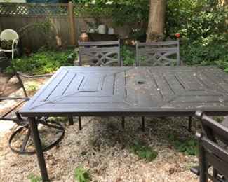 Patio table with six chairs includes red cushions 