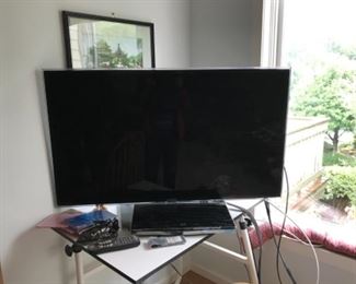 Television barely used (Smart) $145. Drafting Table it Is sitting on is also for sale $75