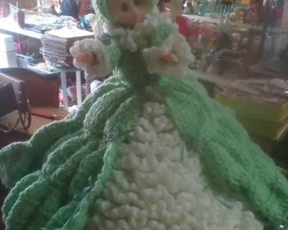 Vintage doll with green crochet dress