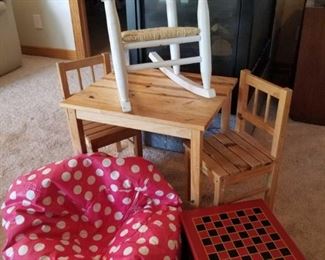 Children's Table and Chairs
Child size table and chairs, with white rocker and pink polka dotted bean bag. Table and chairs are well loved and have writing on them. All items have been well loved by a child.