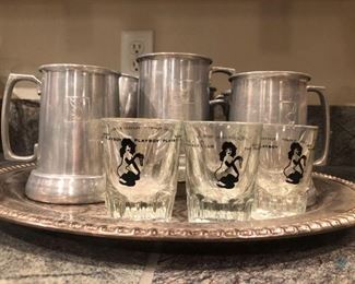 Playboy Shot Glasses and Beer Mugs
Three (3) mugs marked with the Bunny and the others just match style. One shot glass is not Playboy. Also includes a Leonard Silver-plate tray and decorative sign