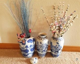 Chinese Pottery Vases
Three (3) blue and white vases with some silk flowers. One has a lid. Minor stains. 13" and 15" tall