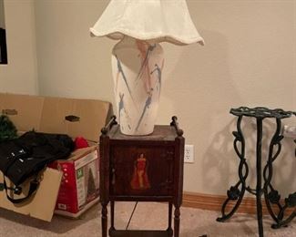 Lamp and Side Table
One (1) 90's style lamp. Powers on. 25" tall. One (1) side table with cabinet on the top. Some damage to the top. Antique condition. 28"H x 12"W x 11"D.