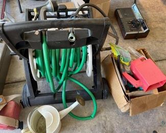 Gardening Items
Gardening items. Includes hose on hose storage rack winder, watering can, sprinkler accessories and more. Used condition.