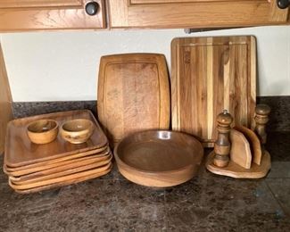 Assorted Wooden Kitchen Items
Seven (7) wooden plates - some with chips and cracks, three (3) wooden bowls of varying sizes, two (2) cutting boards, and more.
