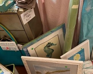 Beach-themed prints and fabric. Also note occasional table and wicker-like planter.