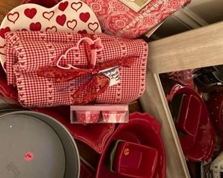 Red cookware, two red valances, large mirror