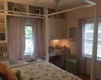 Four poster bed and pink room-darkening shades