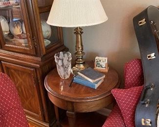 small wood side table, table lamp, crystal vase, antique books 