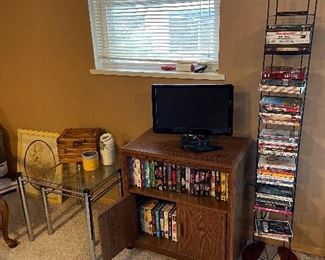 DVDs, flatscreen TV, part of glass top nesting tables, VHS